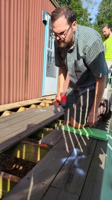 a volunteer cutting deck boards