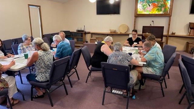 Church community members writing letters for Good Trouble